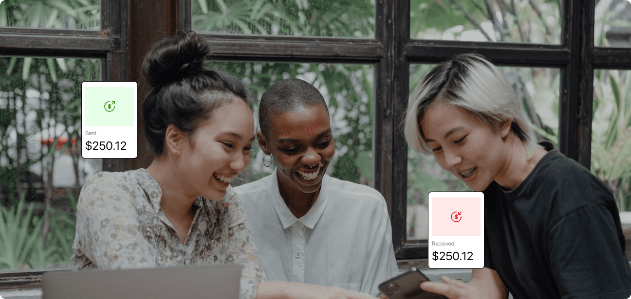 Three people checking a payment on a laptop and phone